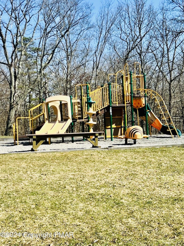 community jungle gym featuring a yard