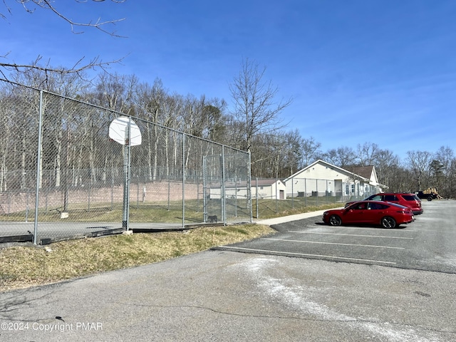 uncovered parking lot featuring fence