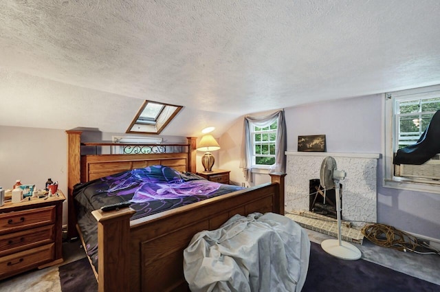 325 Mt Nebo Rd, East Stroudsburg, PA 18301 - bedroom with a skylight, a textured ceiling, vaulted ceiling, multiple windows, and a fireplace with raised hearth