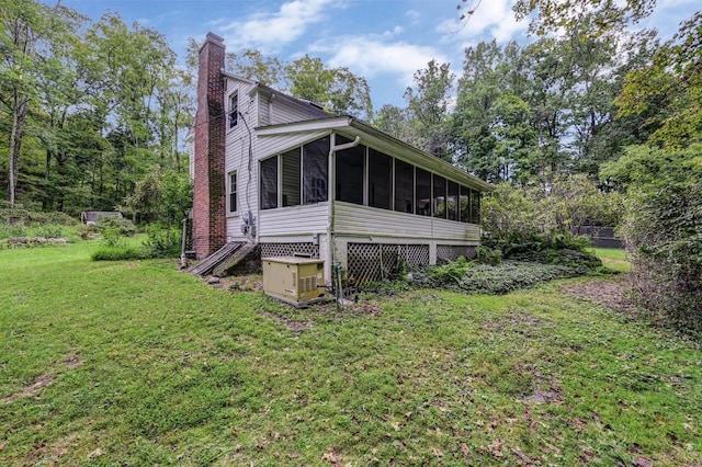 325 Mt Nebo Rd, East Stroudsburg, PA 18301 - view of side of home featuring a sunroom, a chimney, and a lawn
