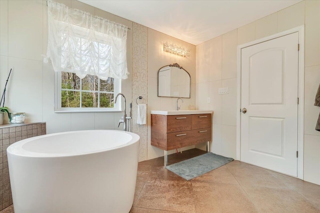 116 Red Bud Ln, Kunkletown, PA 18058 - full bathroom featuring vanity, a freestanding bath, tile patterned floors, and tile walls