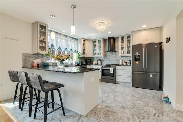 116 Red Bud Ln, Kunkletown, PA 18058 - kitchen featuring appliances with stainless steel finishes, wall chimney range hood, a peninsula, glass insert cabinets, and decorative backsplash