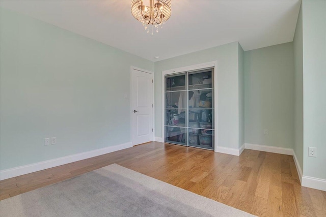 116 Red Bud Ln, Kunkletown, PA 18058 - unfurnished room with wood finished floors and a chandelier