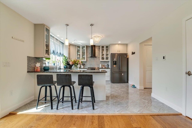 116 Red Bud Ln, Kunkletown, PA 18058 - kitchen featuring freestanding refrigerator, a peninsula, glass insert cabinets, tasteful backsplash, and recessed lighting