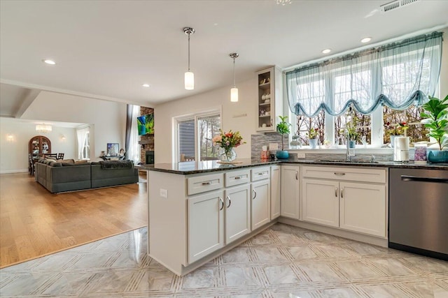 116 Red Bud Ln, Kunkletown, PA 18058 - kitchen featuring dishwasher, dark stone counters, glass insert cabinets, decorative light fixtures, and a peninsula