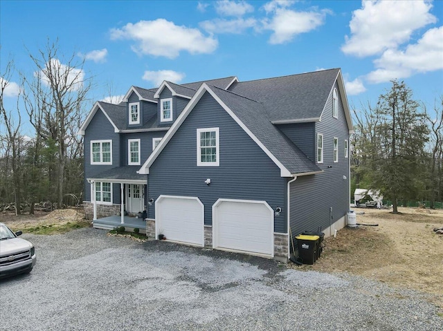 116 Red Bud Ln, Kunkletown, PA 18058 - view of front of property featuring stone siding, roof with shingles, covered porch, driveway, and a garage