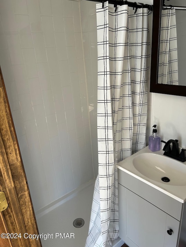 bathroom featuring a stall shower and vanity