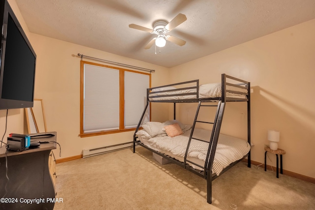 bedroom with baseboards, light colored carpet, a textured ceiling, and baseboard heating