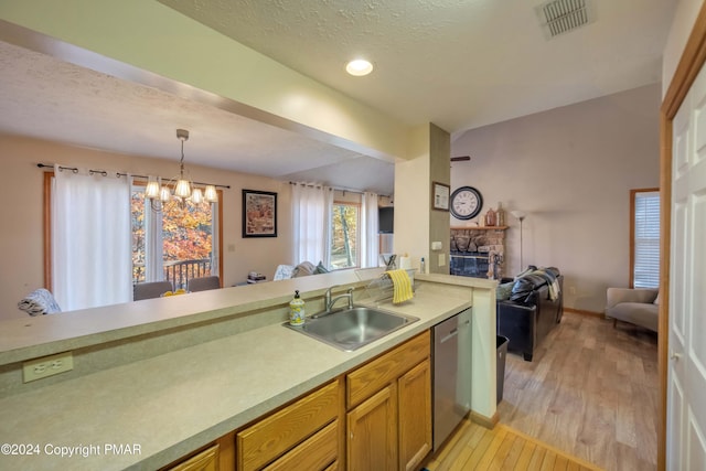 kitchen featuring visible vents, open floor plan, a sink, light countertops, and stainless steel dishwasher