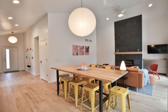 290 Wyomissing Dr, Pocono Lake, PA 18347 - dining room with light wood finished floors, recessed lighting, a large fireplace, baseboards, and a ceiling fan