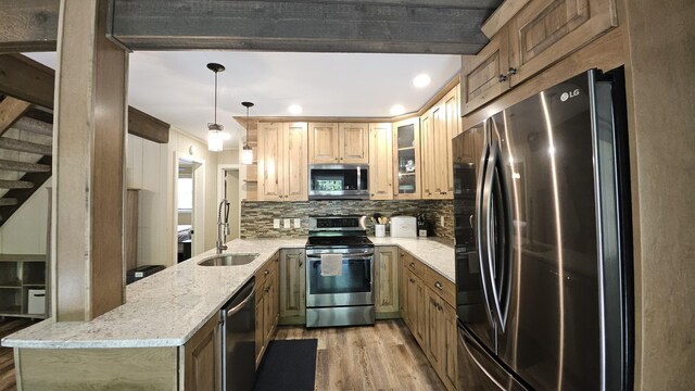 1196 Redwood Ter, Pocono Pines, PA 18350 - kitchen featuring appliances with stainless steel finishes, a sink, light wood-style floors, backsplash, and light stone countertops