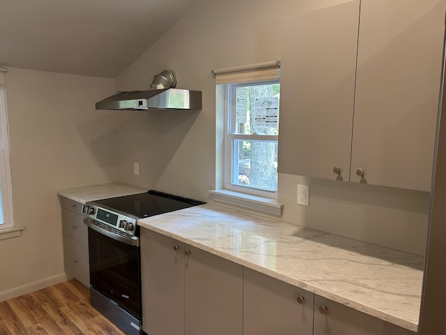 113 Netcong Cir, Pocono Lake, PA 18347 - kitchen with stainless steel electric stove, wall chimney range hood, lofted ceiling, light wood-style flooring, and gray cabinetry