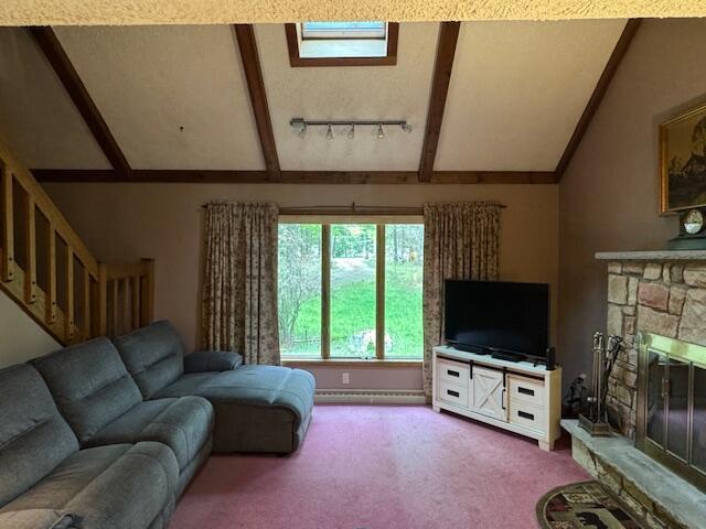122 Sawmill Rd, Pocono Lake, PA 18347 - carpeted living room with a stone fireplace, stairs, and rail lighting