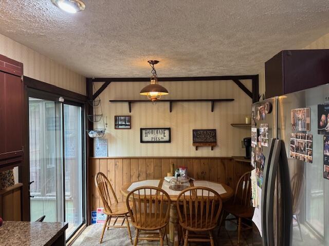 122 Sawmill Rd, Pocono Lake, PA 18347 - dining space featuring wood walls and a textured ceiling
