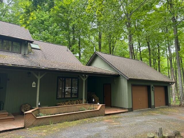 122 Sawmill Rd, Pocono Lake, PA 18347 - view of front facade with roof with shingles, an attached garage, and covered porch