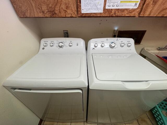 122 Sawmill Rd, Pocono Lake, PA 18347 - laundry area featuring cabinet space, washing machine and clothes dryer, and tile patterned flooring