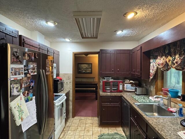 122 Sawmill Rd, Pocono Lake, PA 18347 - kitchen with freestanding refrigerator, white range with electric stovetop, a textured ceiling, stainless steel microwave, and light tile patterned floors