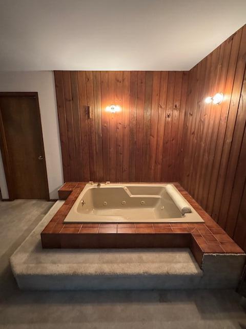 122 Sawmill Rd, Pocono Lake, PA 18347 - bathroom with wooden walls and a whirlpool tub