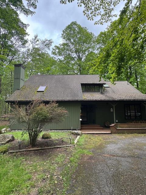 122 Sawmill Rd, Pocono Lake, PA 18347 - view of home's exterior with a chimney, a porch, and driveway