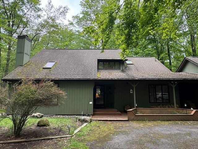 122 Sawmill Rd, Pocono Lake, PA 18347 - view of front facade with a chimney, a porch, and a shingled roof