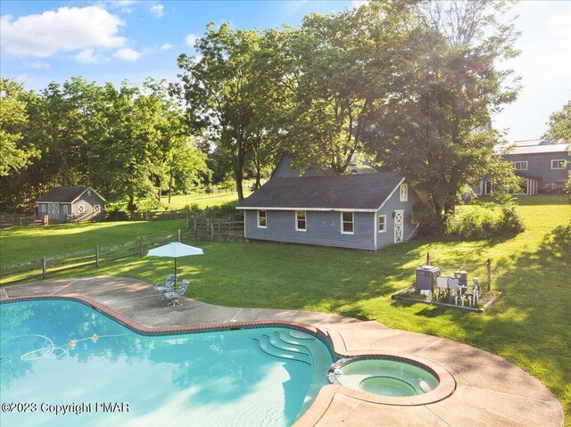 view of pool featuring an outbuilding, a yard, a patio, and fence