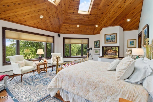 bedroom featuring wooden ceiling, a skylight, high vaulted ceiling, and wood finished floors