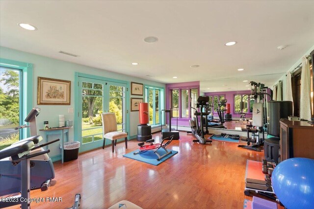 workout room featuring recessed lighting, visible vents, and wood finished floors