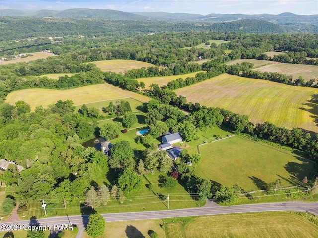 bird's eye view with a rural view, a mountain view, and a view of trees