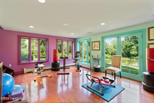 workout room with recessed lighting, wood finished floors, and french doors