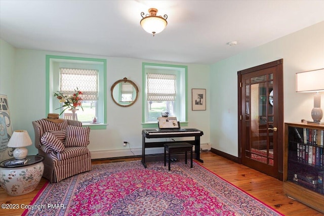 living area with baseboards and hardwood / wood-style floors