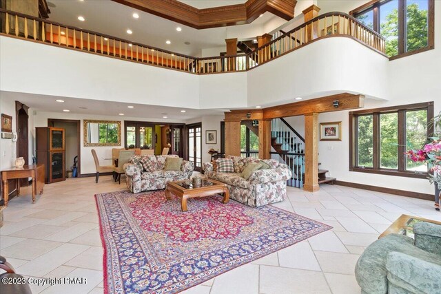 living area featuring light tile patterned floors, stairway, recessed lighting, and baseboards