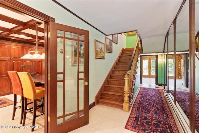 stairway with lofted ceiling, french doors, tile patterned flooring, and baseboards