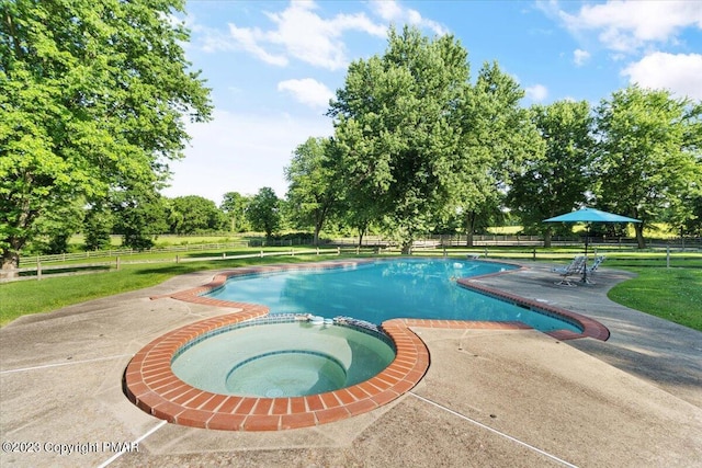 view of swimming pool with a pool with connected hot tub, a yard, a patio, and fence