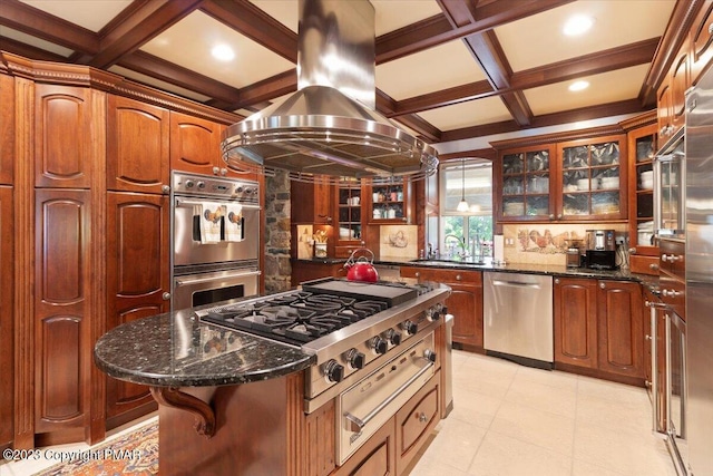 kitchen with coffered ceiling, a kitchen island, appliances with stainless steel finishes, island exhaust hood, and glass insert cabinets