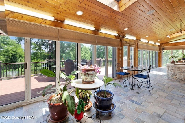 sunroom with a skylight and wooden ceiling