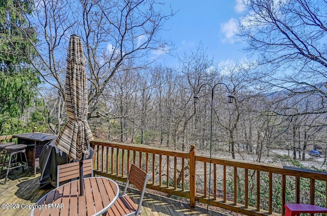 wooden terrace with outdoor dining space