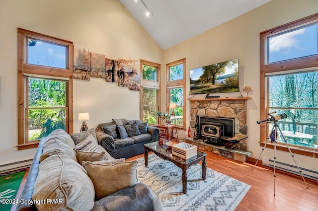 living room featuring high vaulted ceiling, a baseboard radiator, plenty of natural light, and wood finished floors