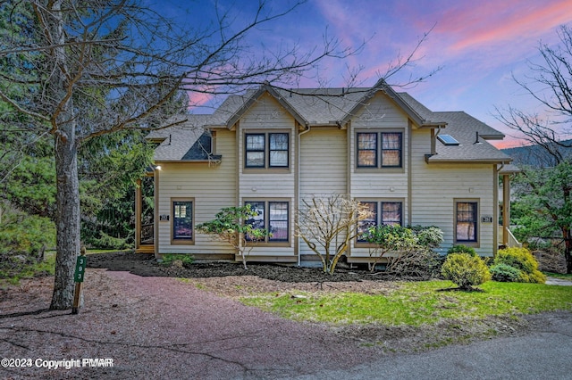 view of front of property featuring roof with shingles