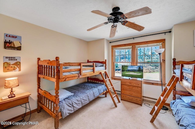 bedroom featuring baseboards, a textured ceiling, and light colored carpet