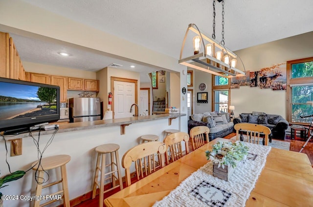 dining room featuring a textured ceiling, stairway, recessed lighting, and a notable chandelier