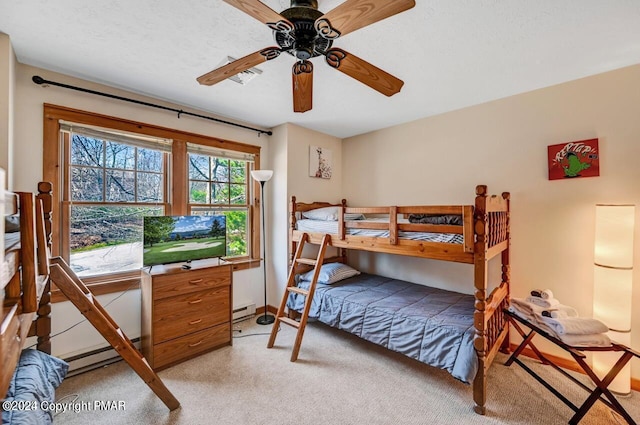 bedroom featuring light carpet, ceiling fan, a textured ceiling, and a baseboard radiator