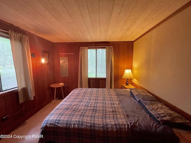 bedroom with wood walls and wooden ceiling