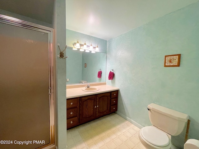 full bathroom featuring a stall shower, vanity, toilet, and tile patterned floors