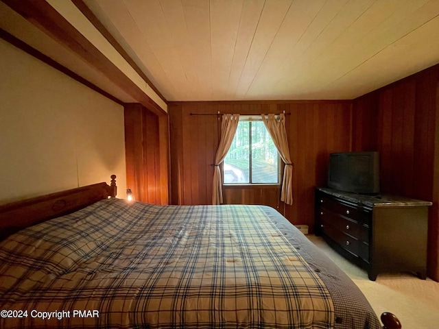 unfurnished bedroom featuring light colored carpet and wood walls