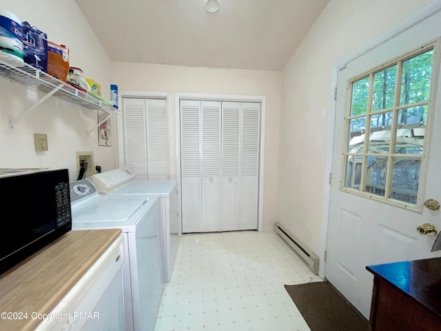 laundry area featuring light floors, laundry area, baseboard heating, and separate washer and dryer