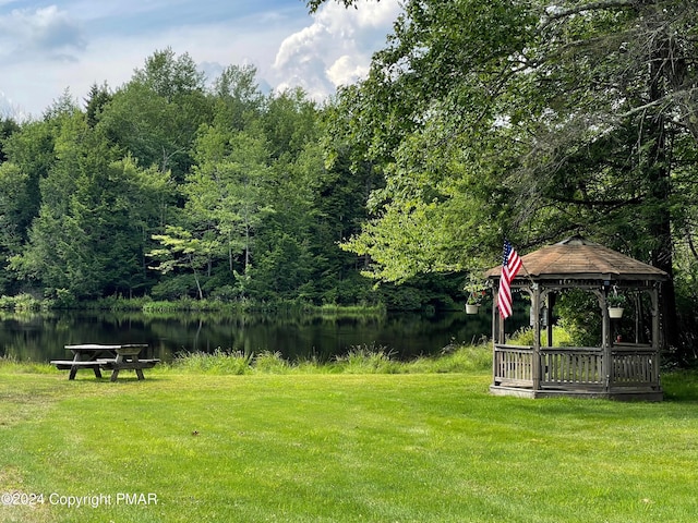 view of yard featuring a gazebo and a water view