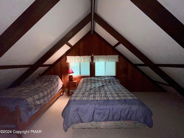 bedroom featuring vaulted ceiling with beams and wooden walls