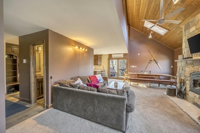 living room featuring wood ceiling, ceiling fan, an AC wall unit, a fireplace, and high vaulted ceiling