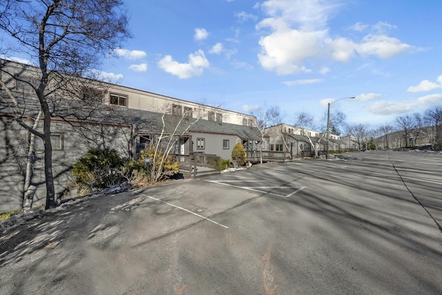 uncovered parking lot featuring a residential view