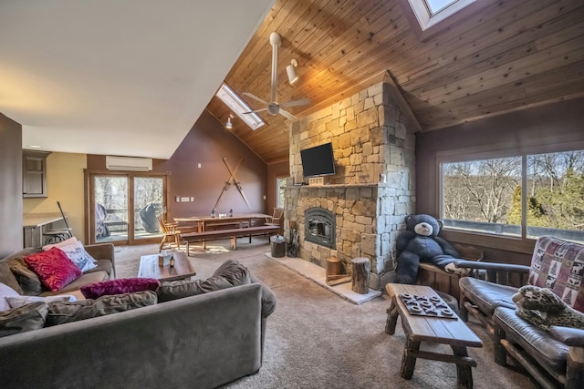 living area with a healthy amount of sunlight, a skylight, a fireplace, and an AC wall unit